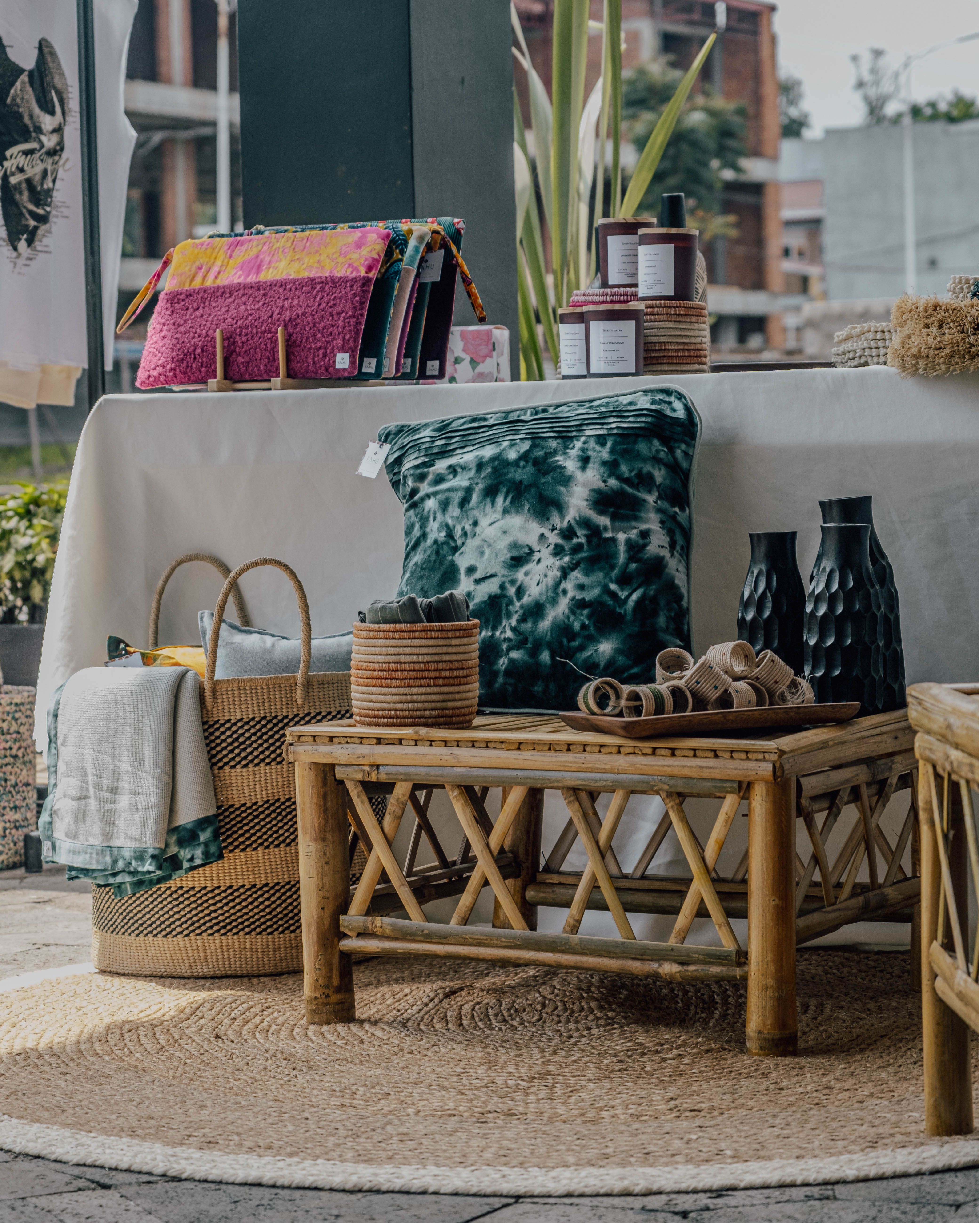 A pair of Upaskar handcrafted bamboo armchairs with natural rattan weave backrests and cream linen seat cushions in a bright Canadian living room interior